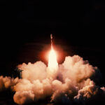 Launch of the spaceship from the spaceport at night. Flight of space shuttle in clouds of smoke. Some elements of this image are furnished by NASA